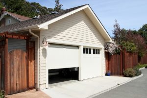 Single white garage door partially open on a residential home