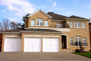 Large brick house with two white garage doors